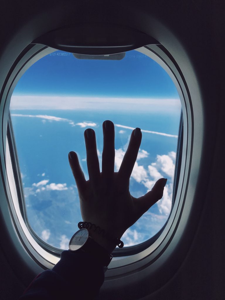 hand on airplane window